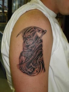 Grim Reaper tatoo on man's right upper arm.