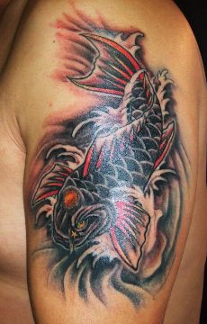 A black koi fish tattoo on man's upper arm.