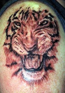 A tiger face tattoo design for men.