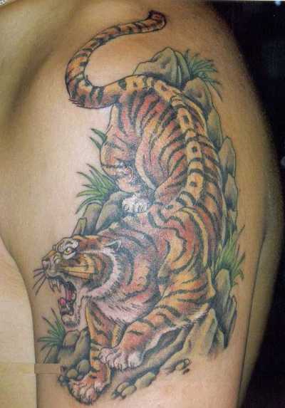 A strentgh tiger tattoo on man's left arm.